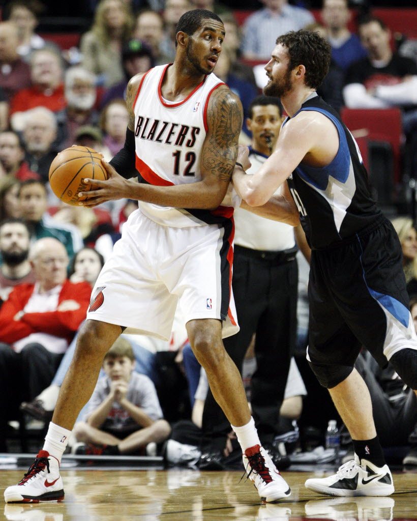 Minnesota Timberwolves' Kevin Love, right, defends against Portland Trail Blazers' LaMarcus Aldridge (12) in the first quarter Sunday.