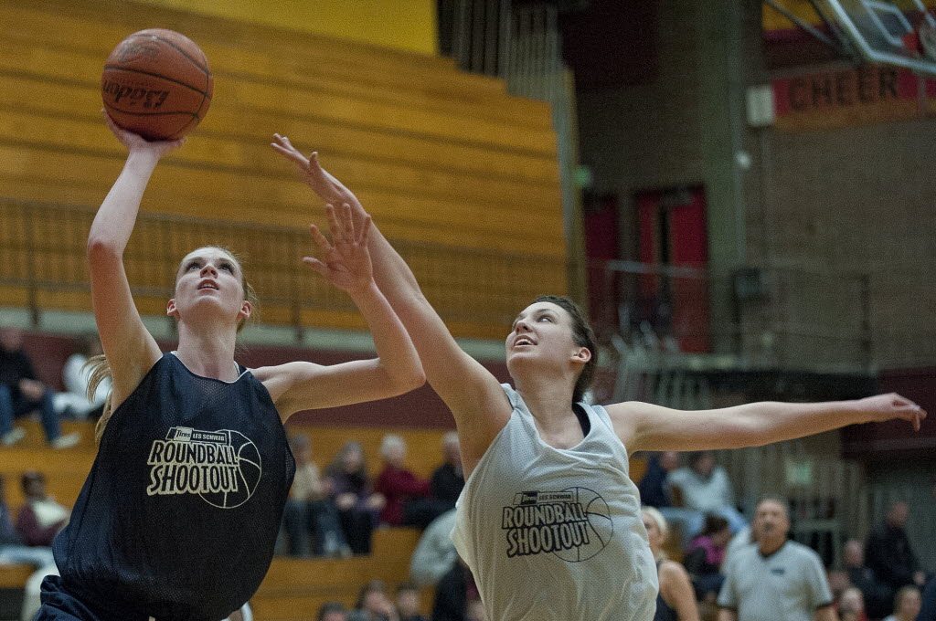 Skyview's Katie Swanson puts up a shot against Heritage High's Emily Myers in the second half of the Les Schwab Roundball Shootout at Prairie High School on Sunday March 25, 2012.