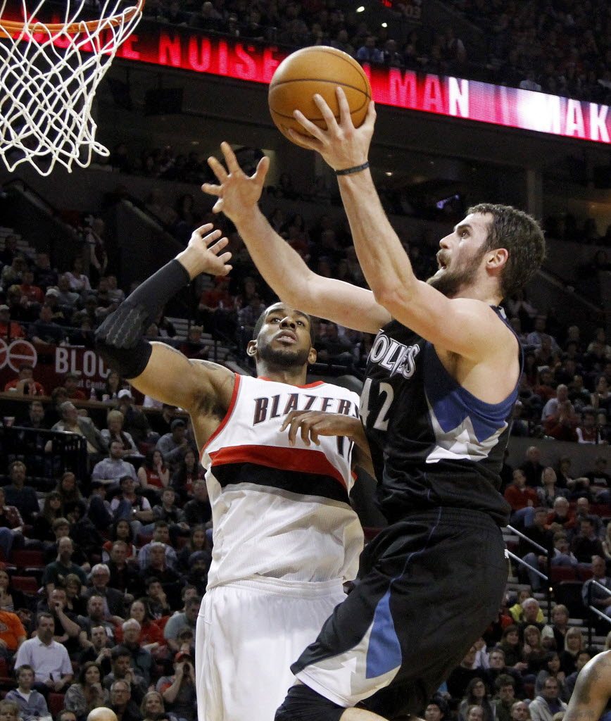 Minnesota's Kevin Love (42) goes to the basket against Portland's LaMarcus Aldridge during the second half Saturday.