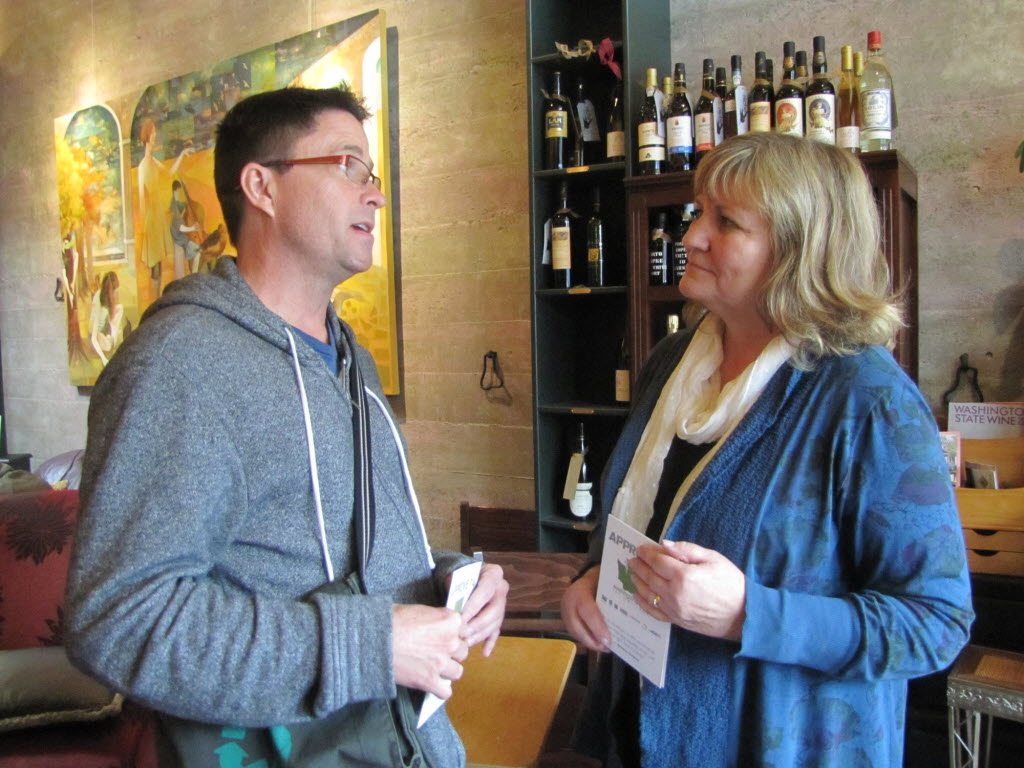 Trudi Inslee, wife of gubernatorial candidate Jay Inslee, discusses gay and lesbian rights with Steve Herndon of Vancouver during a meet and greet Tuesday at downtown Vancouver's Niche Wine and Art Bar.