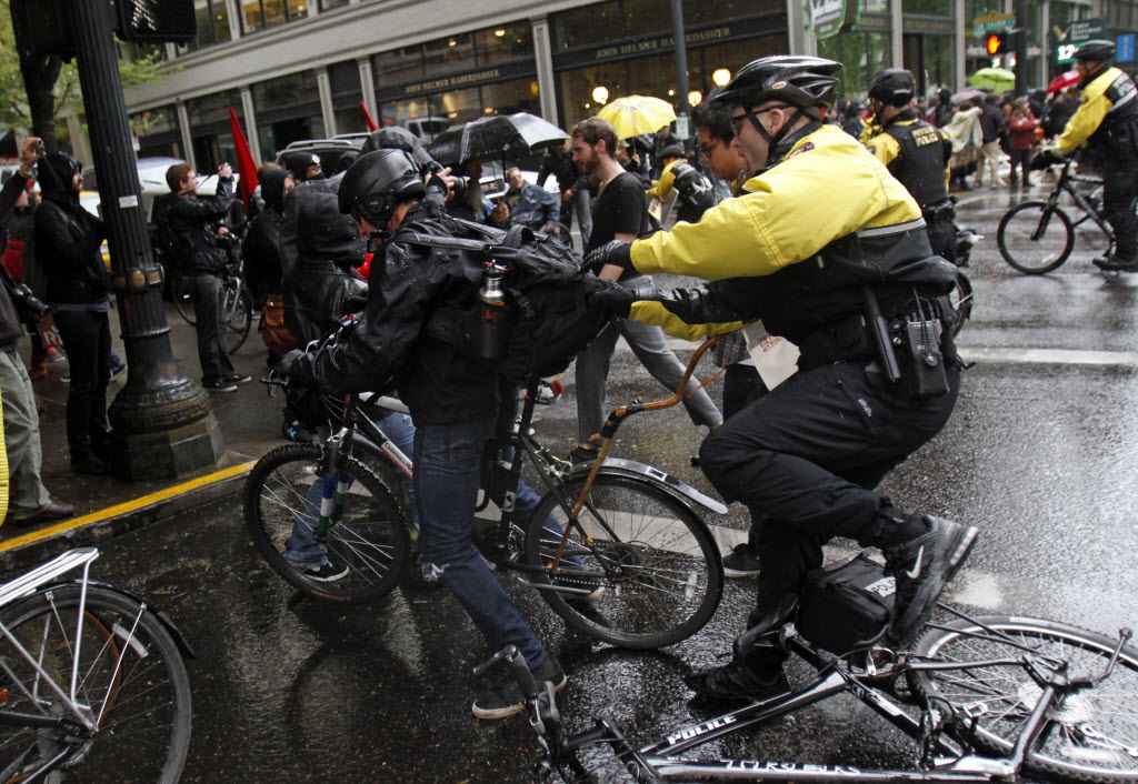 Portland police move in to make arrests during a May Day march and protest in Portland on Tuesday. Hundreds of activists across the U.S.