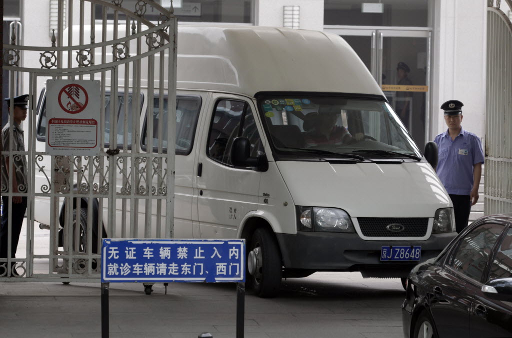 A van with covered windows leaves in a convoy under a tight security from the hospital where blind activist lawyer Chen Guangcheng was recuperating in Beijing, China, Saturday.