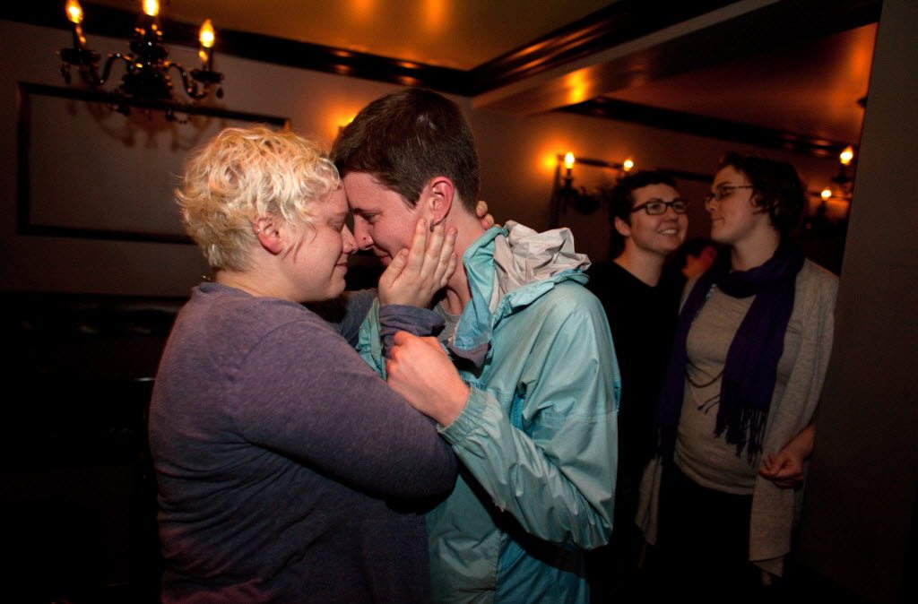 Kara Haney, left, and her partner of eight years Kate Wertin embrace in the Lobby Bar in Seattle's Capitol Hill neighborhood after the Washington State Senate passed a bill that would legalize gay marriage in Washington State on Wednesday.