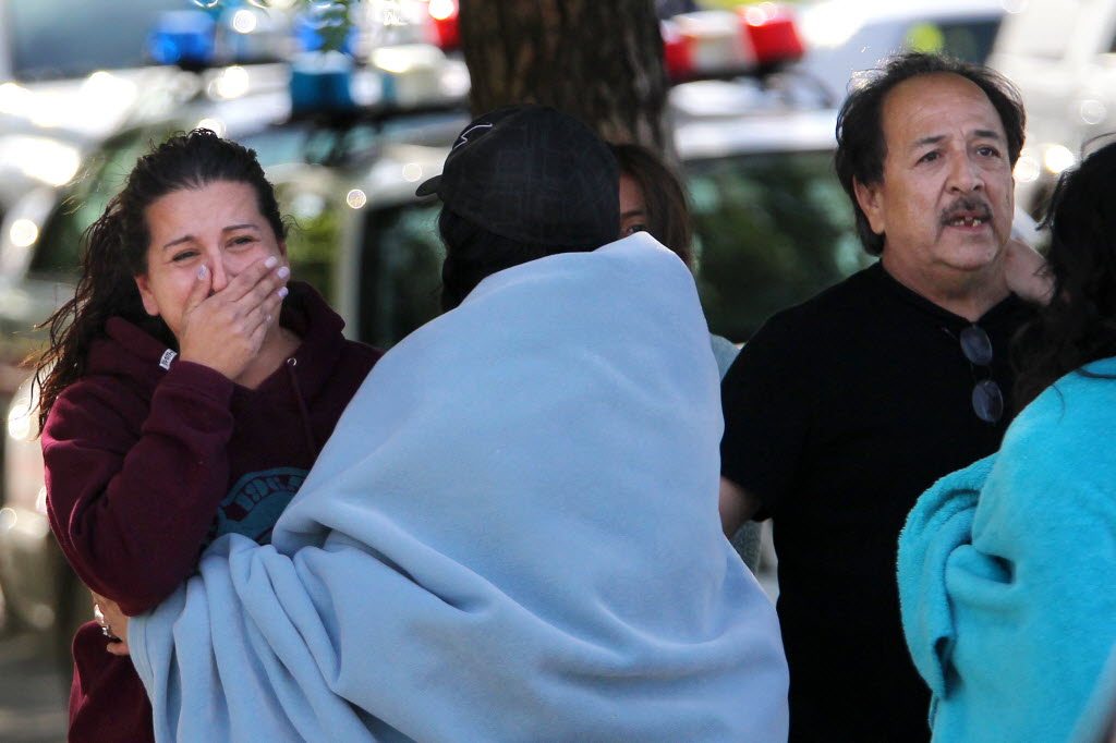 Jessica Reyes, Jason Valdez's sister, and his father, Duane Valdez, react Saturday after hearing a loud explosion as SWAT teams storm the motel room where Jason Valdez was allegedly holding a hostage in Ogden, Utah. Jason Valdez remains hospitalized in critical condition from a self-inflicted gunshot wound.