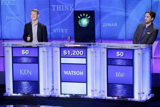 In a Jan. 13, 2011 file photo, &quot;Jeopardy!&quot; champions Ken Jennings, left, and Brad Rutter, right, flank a prop represneting Watson during a practice round of the &quot;Jeopardy!&quot; quiz show in Yorktown Heights, Watson is being tapped by one of the nation's largest health insurers, WellPoint Inc., to help diagnose medical problems and authorize treatments.