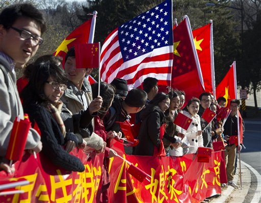 Demonstrators line up to welcome the arrival of Chinese Vice President Xi Jinping in Washington, Tuesday, Feb. 13, 2012.