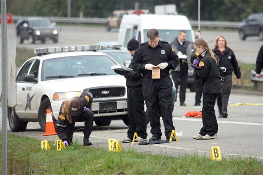 Washington Sate Patrol investigators gather evidence at the scene of a shooting on Highway 16 in Gorst near Bremerton, Wash. where a Washington state trooper was shot and killed on Thursday, Feb. 23, 2012. The trooper, a 16-year veteran of the Washington State Patrol, had stopped a pickup truck around 1 a.m. on Highway 16 about 20 miles west of Seattle across Puget Sound.