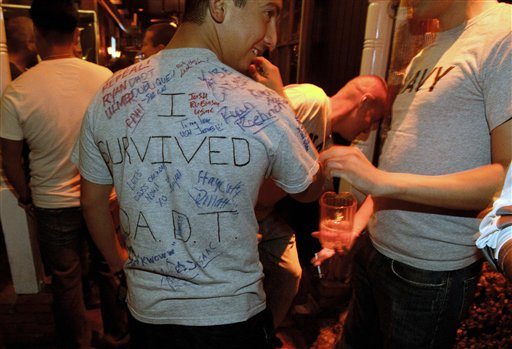 A man who is active-duty in the Navy, and only gave his name as Matt, wears a shirt being signed by others that reads &quot;I survived D.A.D.T.&quot; (don't ask, don't tell) shortly before midnight during a celebration for the end of the policy late Monday, Sept. 19, 2011, in a bar in San Diego. After years of debate and months of final preparations, the military can no longer prevent gays from serving openly in its ranks.