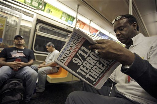 An early morning subway commuter reads a newspaper with a front page announcing news of an al-Qaida terror threat, Friday, Sept. 9, 2011 in New York. Just days before the 10th anniversary of the Sept. 11 attacks, U.S. counterterrorism officials are chasing a credible but unconfirmed al-Qaida threat to use a car bomb on bridges or tunnels in New York City or Washington. It is the first &quot;active plot&quot; timed to coincide with the somber commemoration of the terror group's 9/11 attacks a decade ago that killed nearly 3,000 people.