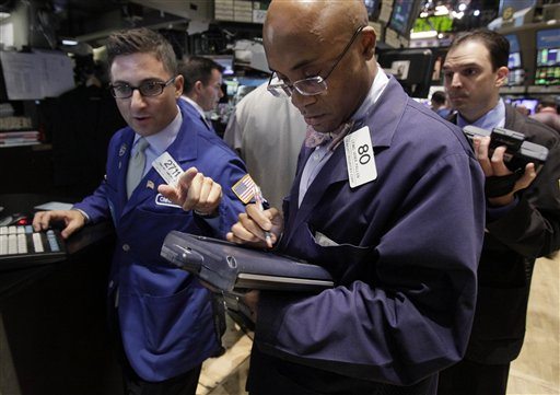 In this Aug. 18, 2011 photo, trader Lewis Vande Pallen, center, works on the floor of the New York Stock Exchange. Global stocks slid again Friday, Aug. 19, as fears of a possible U.S. recession combined with ongoing worries over Europe's debt crisis, which is stoking acute fears over the continent's banking sector.