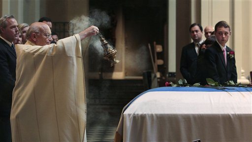 Smoke bellows from an incense pot as Rev. Paul Fitterer waves it over the casket of former Washington Gov. Albert Rosellini during a memorial service Monday at St.