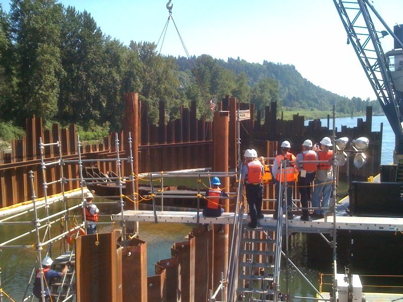 Workers remove the last piece of the derelict barge Davy Crockett from inside a Columbia River cofferdam in August.