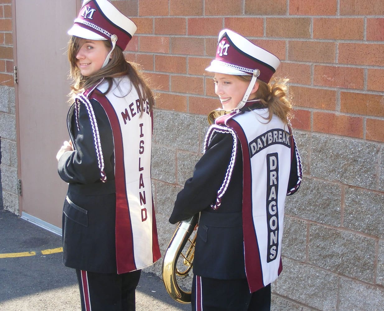 Daybreak Middle School seventh-graders Jessie Wiseman, left, and Briana Robbins, display the uniform overlays, one with the Mercer Island identifier and one with new Daybreak Dragons patches.