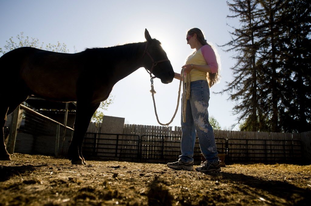 Jaimie Hiskey stands in the pasture behind her home with her horse Kayne on Thursday, May 19,  in Nampa, Idaho.