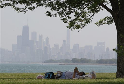 A woman rests during hot weather at Montrose beach in Chicago, Wednesday, June 8, 2011. Temperatures peak within a few degrees of the 97-degree 1933 record. Hottest early season spell in 34 years to break amid powerful, potentially severe storms Wednesday evening and night. (AP Photo/Nam Y.