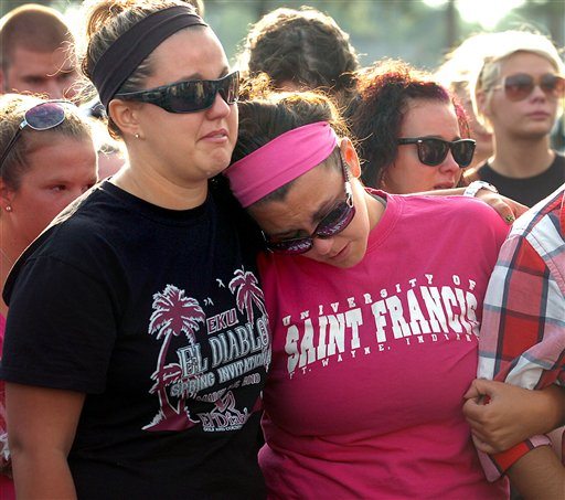 Nikki LeRose, left, and Kelsea Jackson remember their friend Alina Bigjohny at a memorial gathering at Wayne High School in Fort Wayne, Ind., Sunday, Aug 14, 2011. Bigjohny, 23, a 2007 graduate from Wayne, was killed Saturday night in the stage collapse at the Indiana State Fair.