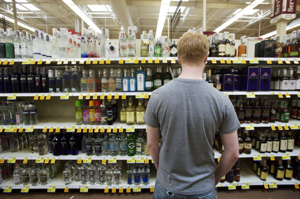 A shopper looks over his liquor choices at the Grand Central Fred Meyer store.
