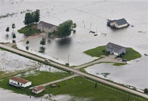 Homes sit in flood water, near Bartlett, Iowa, Monday, June 13, 2011.