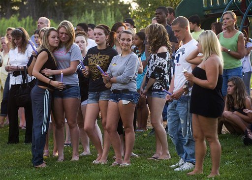 Several hundred people attend a prayer vigil, following a multiple death shooting in Copley Twp. a suburb of Akron, Ohio, Sunday, Aug. 7. 2011. A man apparently angry with his girlfriend gunned down two people outside an Ohio home in Copley Twp., Sunday, and two more in a car, then shot his girlfriend in a rampage that left eight dead including the gunman.