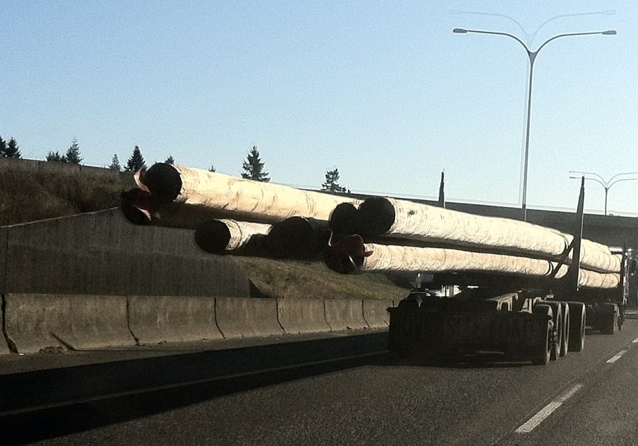This truck is carrying large lumber.