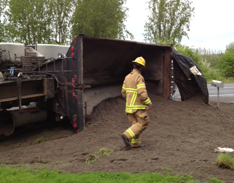 A dump truck driver was sent to the hospital with minor injuries after his rig went off the road on state Highway 502 and flipped on its side.