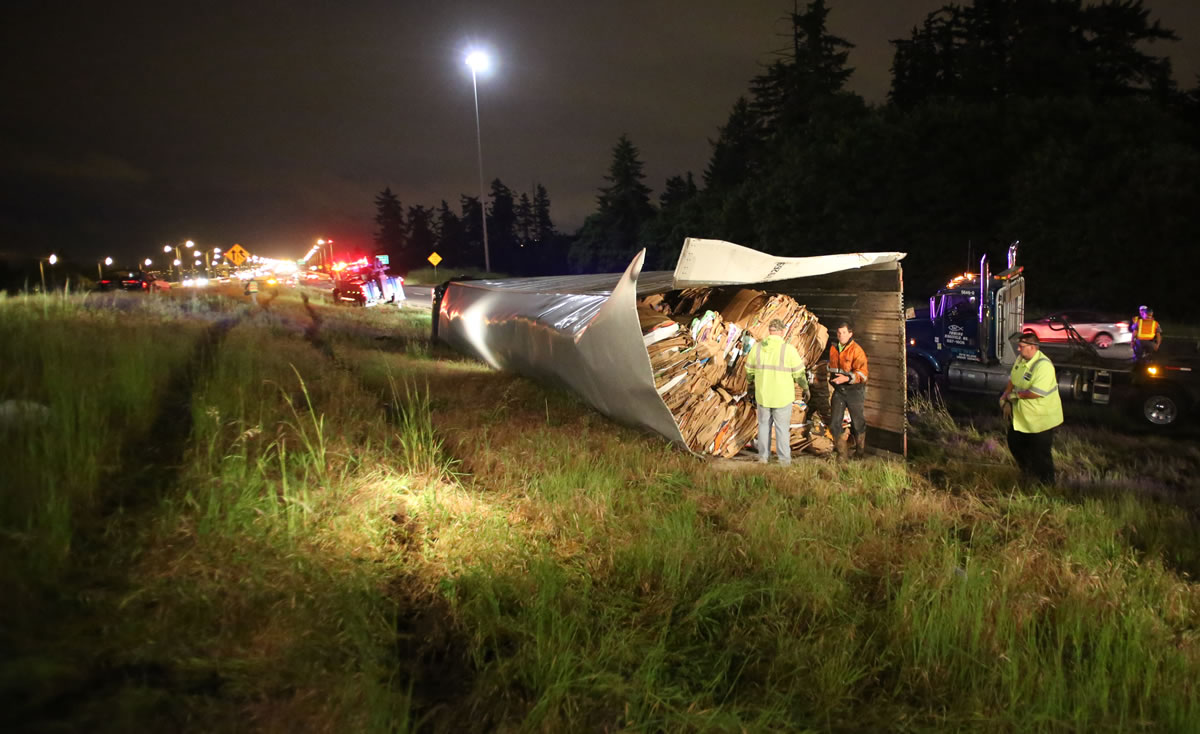 TLC Towing crews respond to an overturned semi truck on the state Highway 14 ramp to south Interstate 205 early Tuesday.