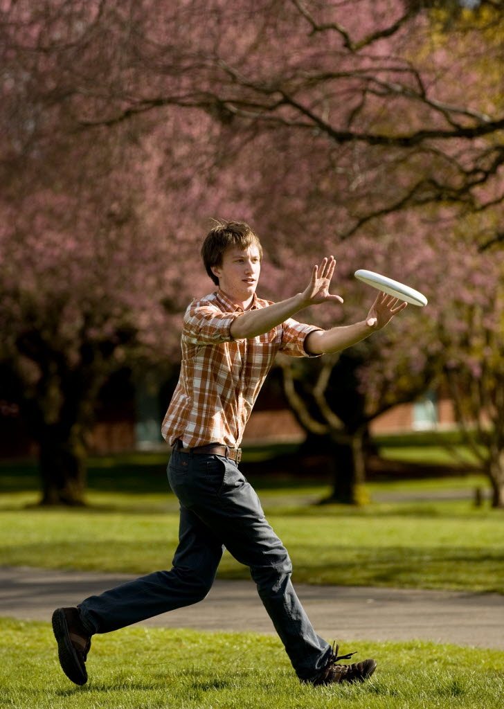 Geoff Kunkle, 22, plays frisbee with a friend between classes at Clark College this week.