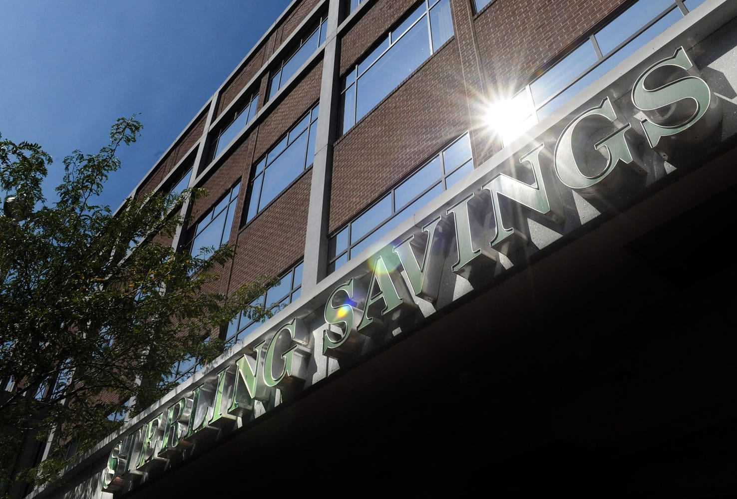 Spokane-based Sterling Savings Bank's parent company is laying off 6 percent of its workforce.