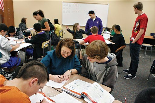 In an undated photo Kiona-Benton math teacher Susan McTavish, front, works with Stephan Tenisch, 15, during a pre-algebra class as GEAR UP tutors Teresa Wight, back left, Jaime Garcia, in purple, and Montana McAllister, right, help other students one on one. Kiona-Benton won Washington Achievement Awards in overall excellence and language arts.