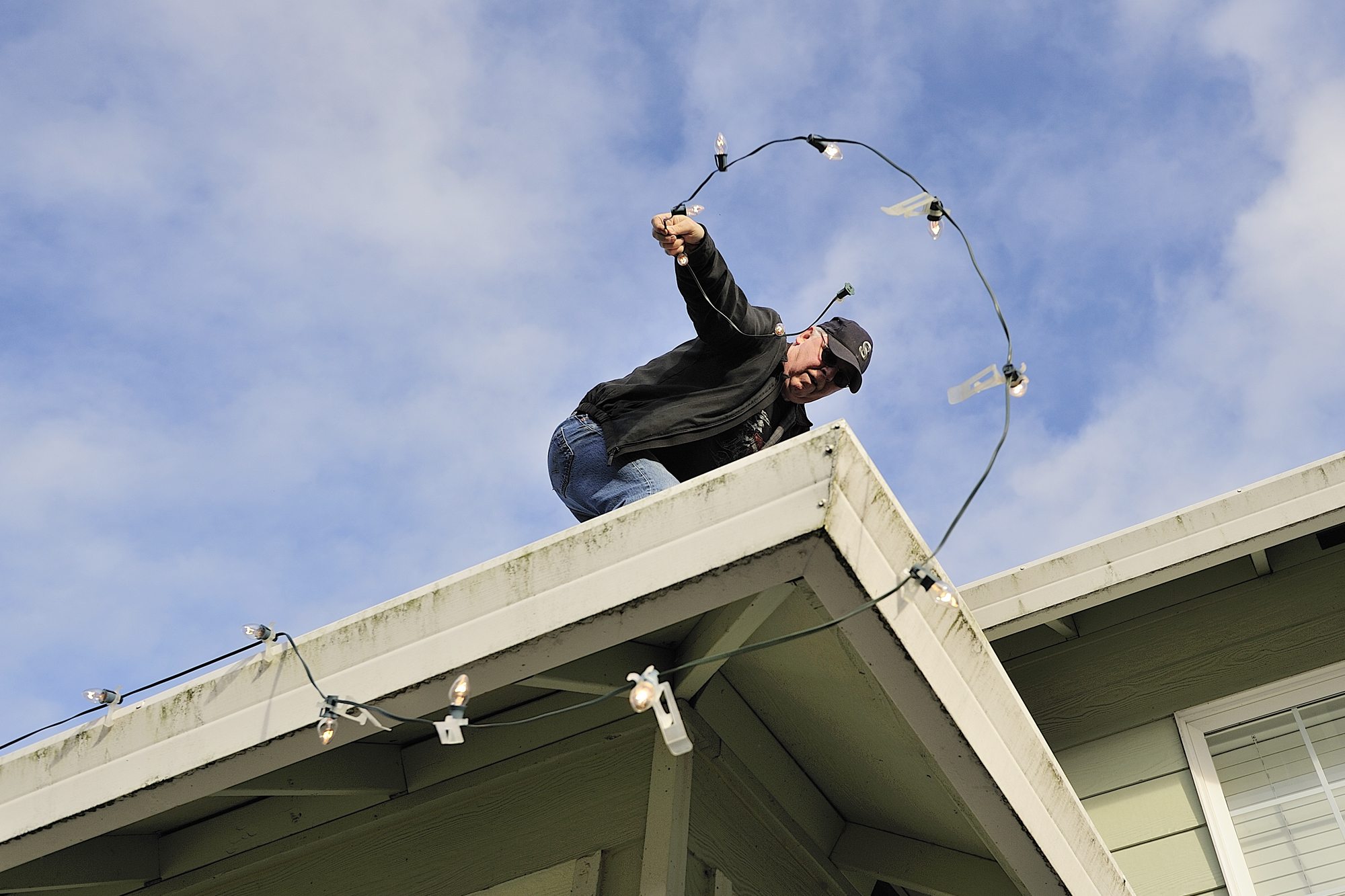Art Rairdon takes advantage of what was forecast to be the last dry day this week to put up his Christmas lights. &quot;I should have put them up yesterday,&quot; said Rairdon.