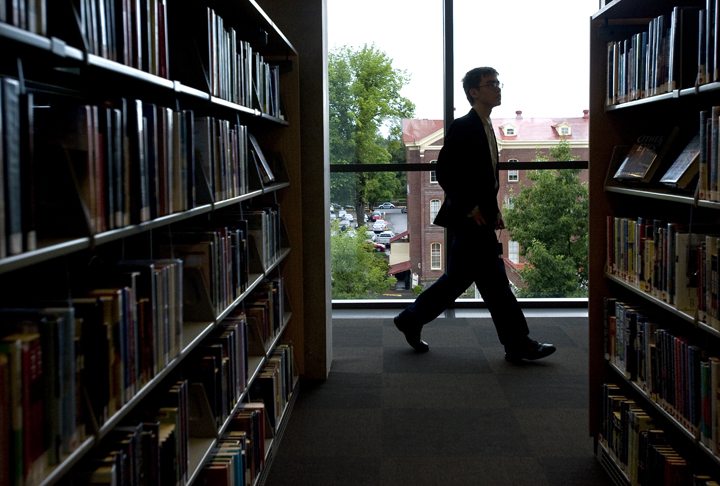 A patron walks past rows of books on the fifth floor during the grand opening of the Vancouver Community Library on Sunday July 17, 2011.