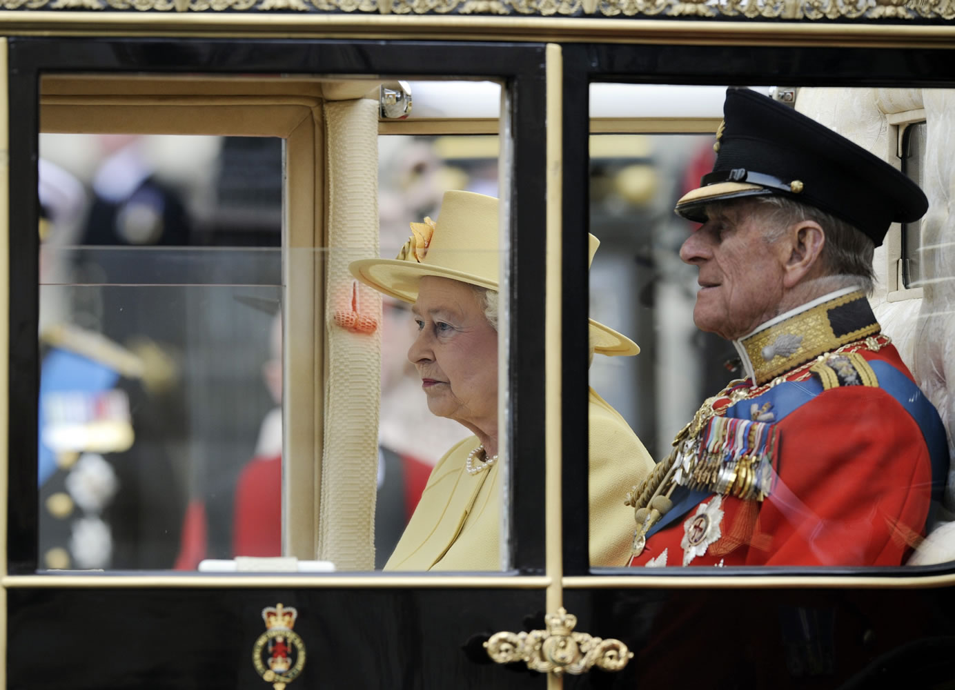 Britain's Queen Elizabeth II and Britain's Prince Philip sit in their carriage outside Westminster Abbey after the Royal Wedding for Britain's Prince William and his wife Kate, Duchess of Cambridge in London Friday, April, 29, 2011.
