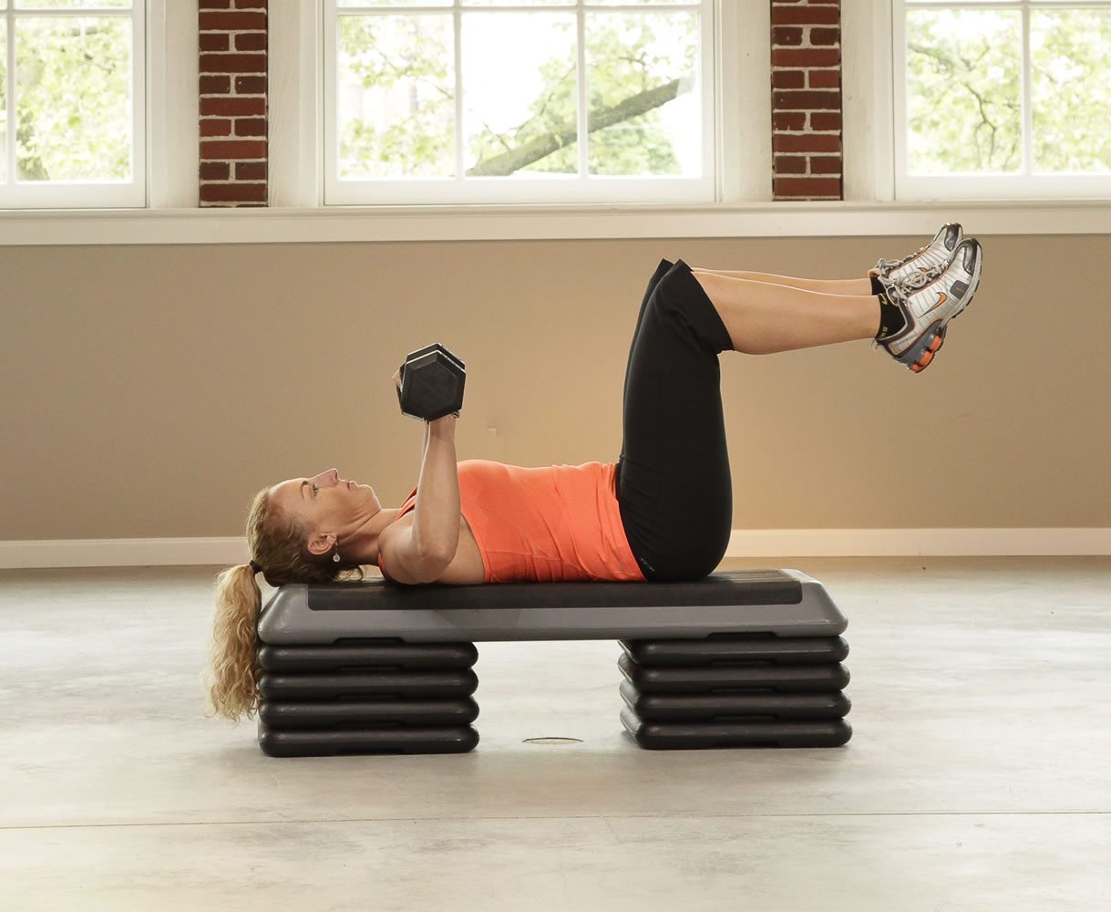 Dumbbell chest press. Lie back on a bench. Position your body so that your feet are suspended in the air (this will involve more balance and torso stabilization).