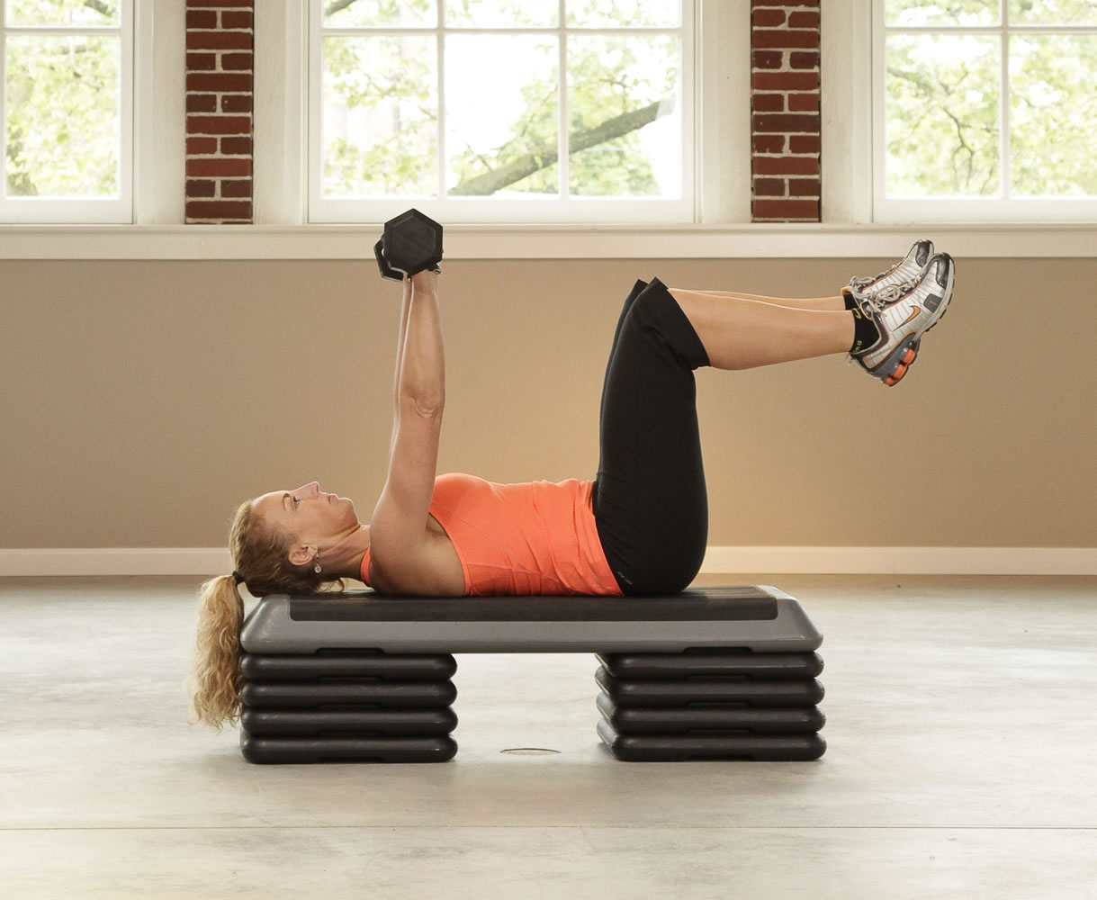 Dumbbell chest press.  Lie back on a bench. Position your body so that your feet are suspended in the air (this will involve more balance and torso stabilization).