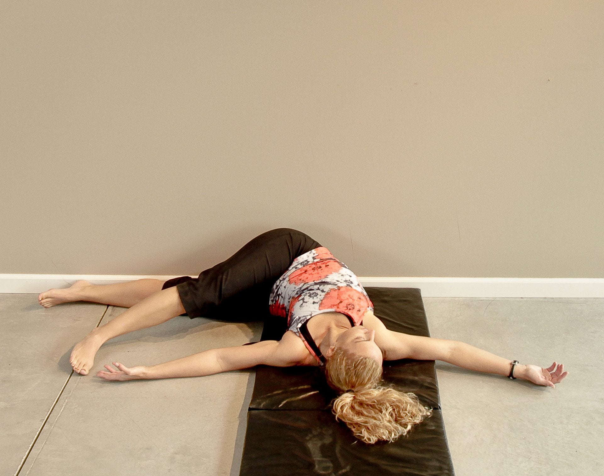 Today's stretch is hips and back. Lay on your back and start with both legs straight against the wall. Now slowly let both legs fall to one side. Bend the bottom leg and keep the top leg straight.