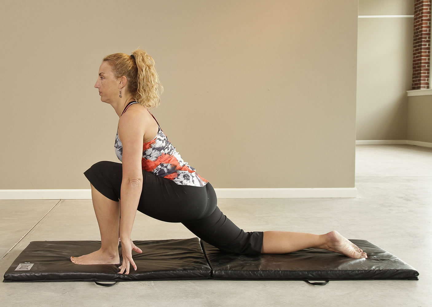 Hip flexor. Position yourself in a lunge position with your front knee positioned over the front ankle and your back knee positioned comfortably on a mat or towel.  Straighten your spine so your posture is fully erect. Lightly press the hip forward.