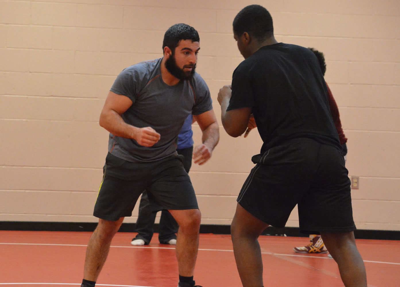 Fort Vancouver High School wrestling coach Saleh Batroukh, left, does a drill with one of his wrestlers during practice on Wednesday.