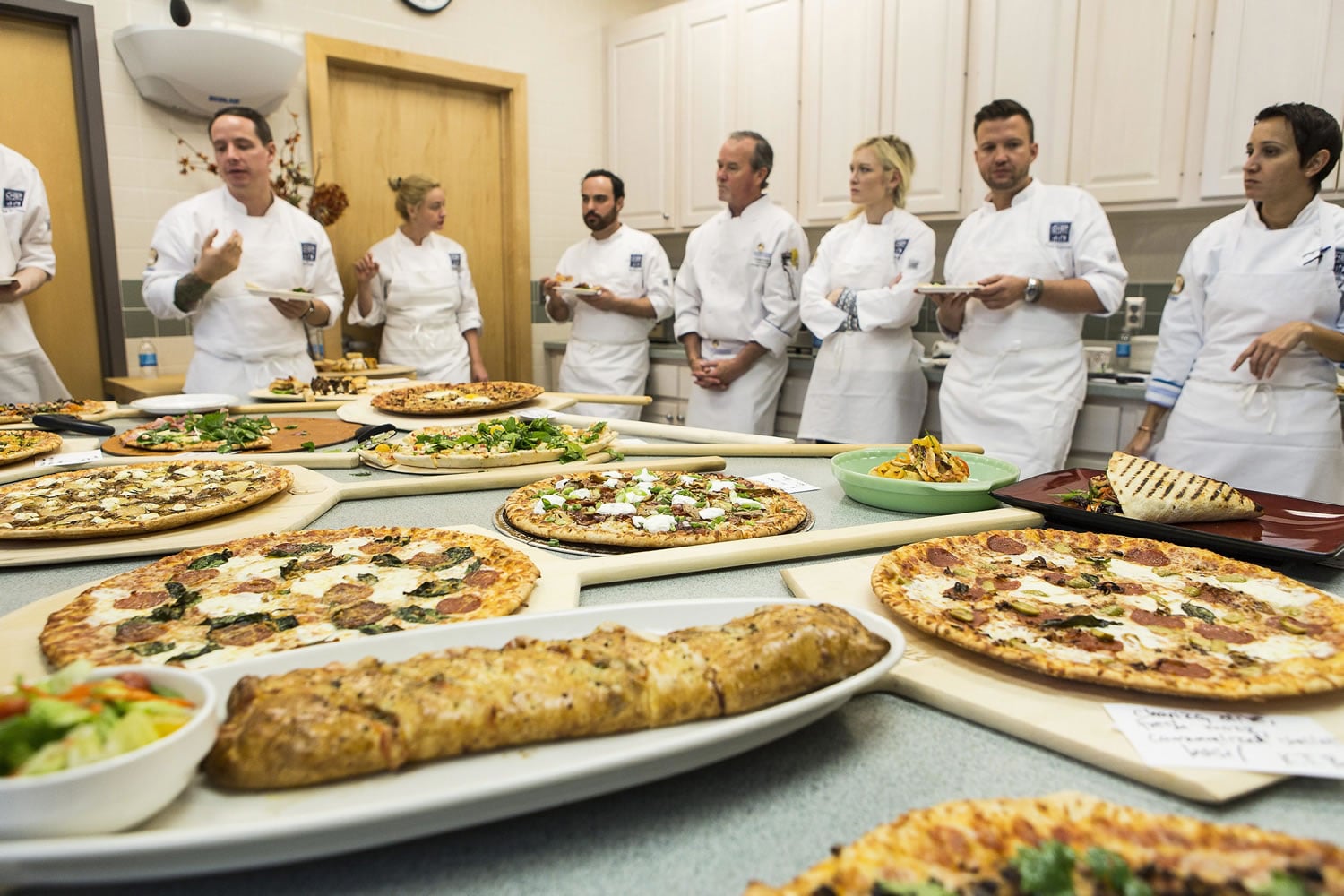 Chefs participating in the 2015 Chef Collective discuss dishes at the Schwan Food Company facilities in Marshall, Minn., in October.