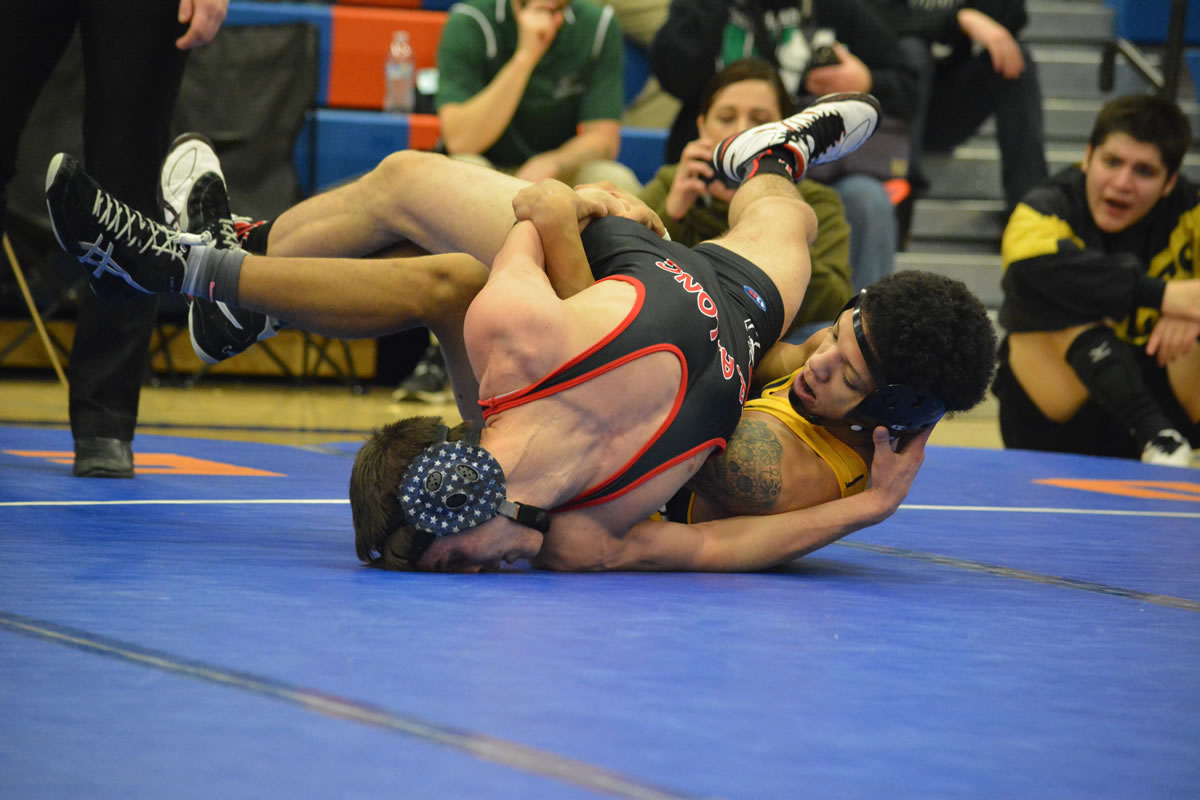 Darion Green of Hudson's Bay, right, wrestles with Orion Yates of R.A. Long during the Class 2A Greater St. Helens League Sub-Regional Tournament on Saturday at Ridgefield High School. (Micah Rice/The Columbian).