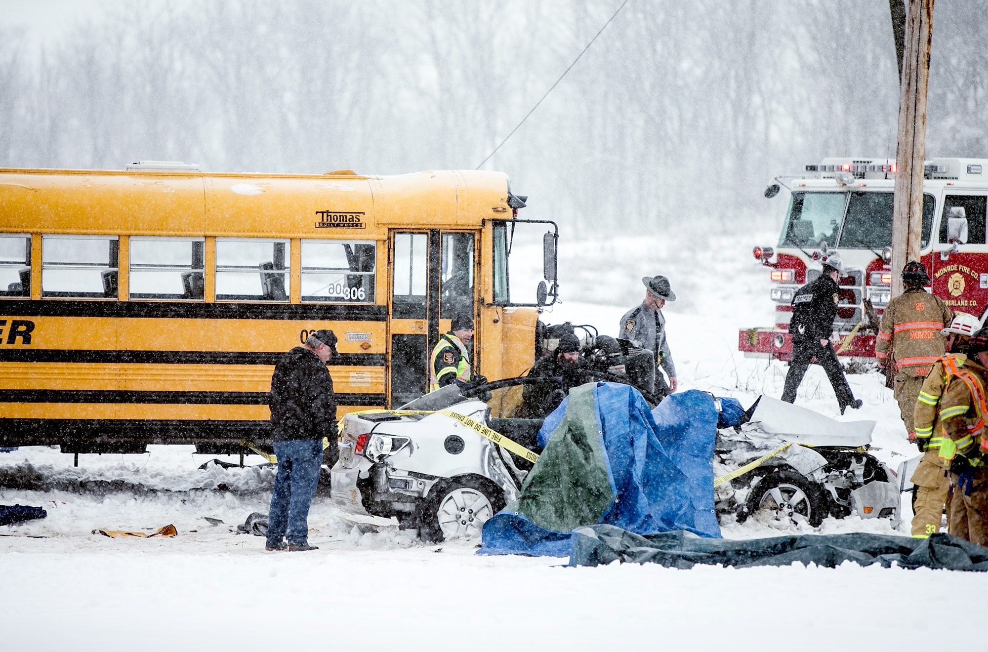 Emergency personnel respond to a fatal accident  involving a school bus and a single vehicle Tuesday in Cumberland County, Pa. A 20-year-old woman who was a passenger in the car was killed.