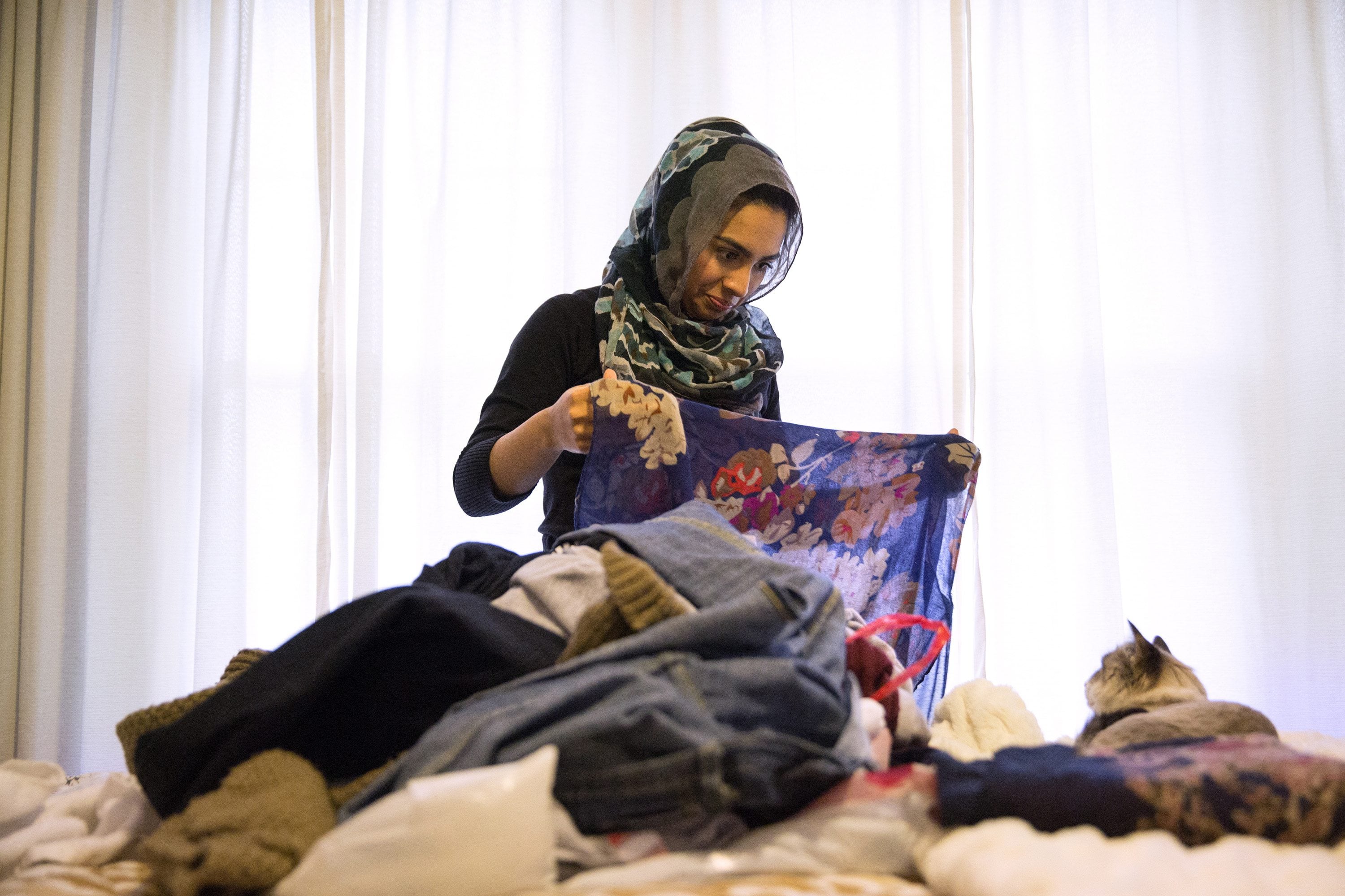 Saarah Bhaiji, 16, folds one of her many headscarves at her home Jan. 31 in Glenview, Ill. Bhaiji teaches at the Muslim Education Center in Morton Grove on Sundays and attends Glenbrook South High School as a junior during the week, where she said her experience as a Muslim has been mostly positive.