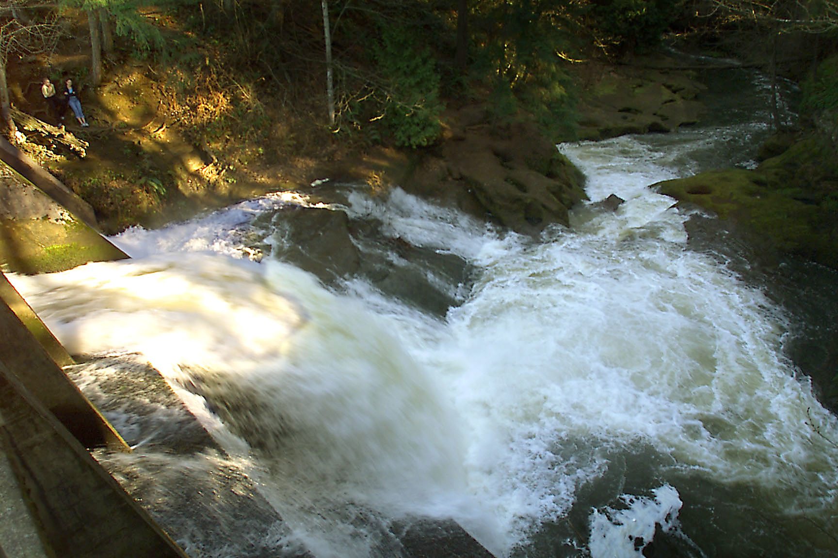 The dam at Round Lake spills water down Lacamas Creek, one of several watersheds chosen for Clark County&#039;s stream monitoring program.
