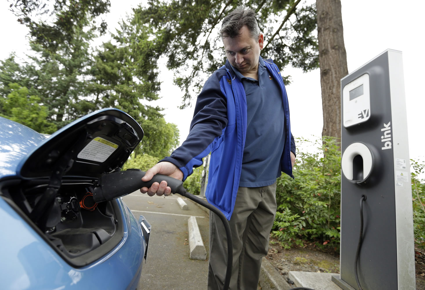Patrick Conner plugs in his Nissan Leaf at a charging station at the public library in Hillsboro, Ore., in May 2015. West of the Cascades, it&#039;s not hard to find a place to give a battery a fill-up, but Avista says more stations in Eastern Washington, 45 of them in public sites, could be a big help in the state&#039;s goal to go from 12,000 electric vehicles to 50,000 by 2020.