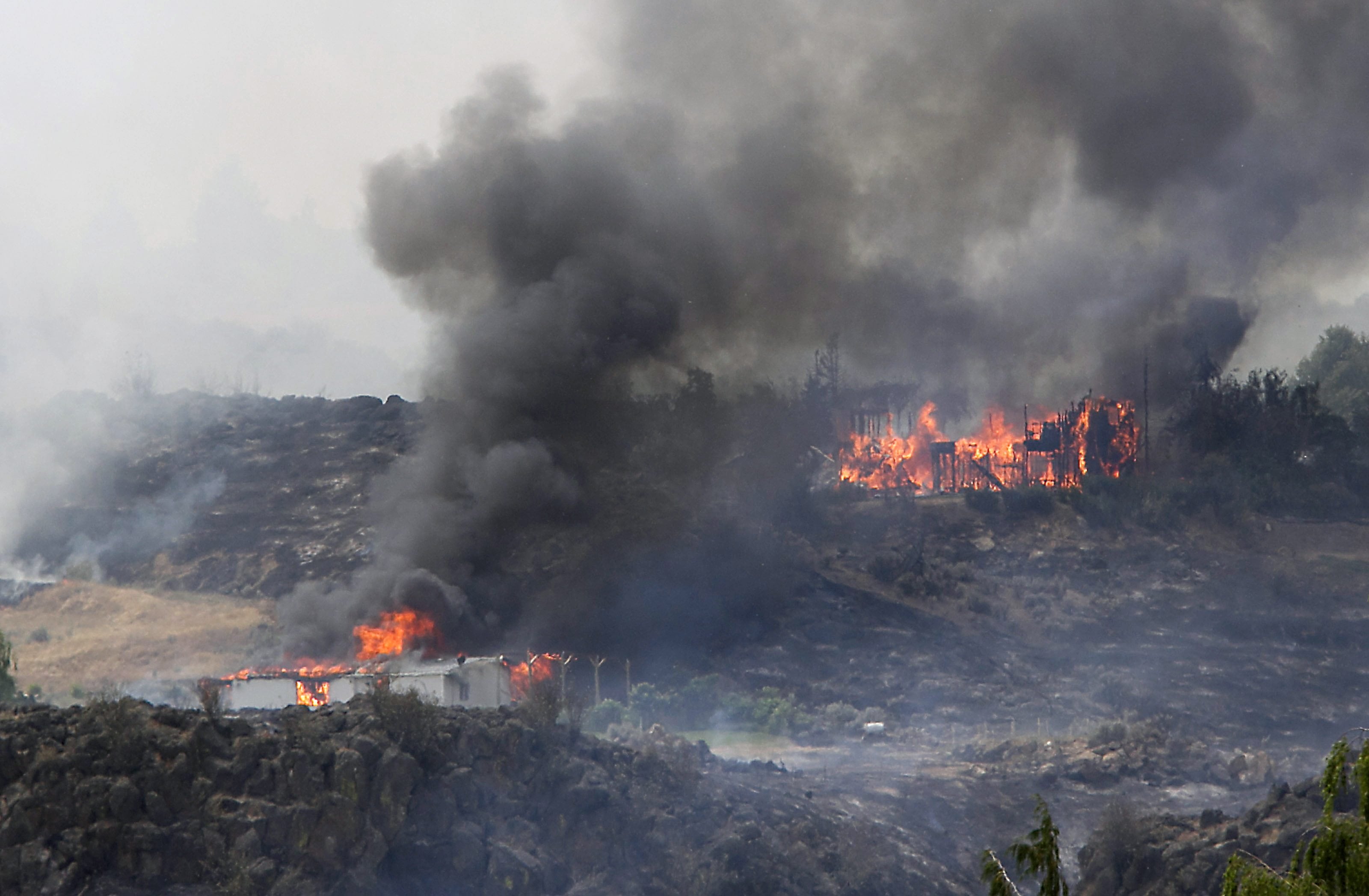 A wildfire destroys two homes west of Yakima June 15, 2015.