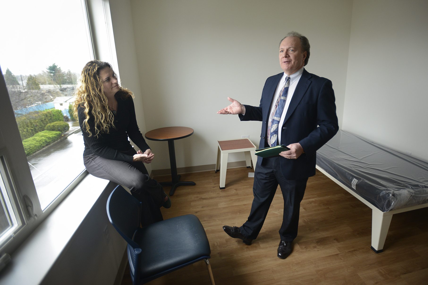 Amy Reynolds of Share, left, and Steve Towell of the Vancouver Housing Authority provide a tour of Lincoln Place, a 30-unit apartment complex in downtown Vancouver for the chronically homeless.