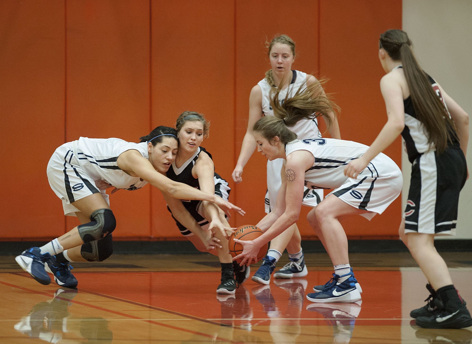 Skyview's Maddie Lord (32) from left, Camas'Meghan Finley (2) and Skyview's Ashlee Comastro (30) battle for a loose ball in the first quarter Tuesday evening, Feb. 16, 2016 at Battle Ground High School.