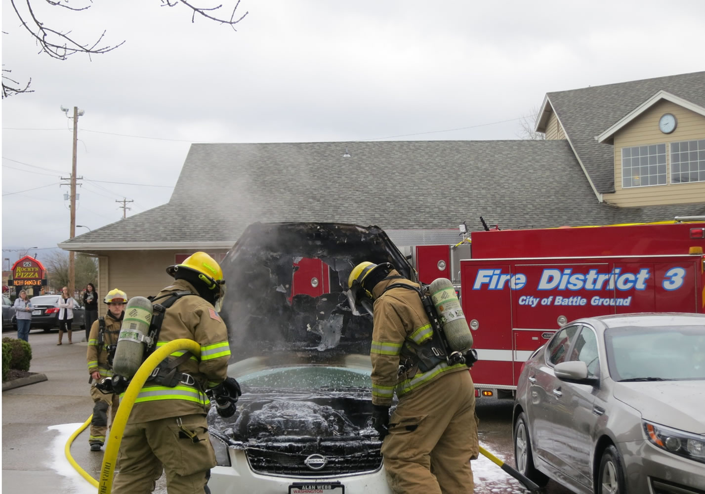 Firefighters douse a car fire at 15 S..W 20th Ave. in Battle Ground Monday morning.