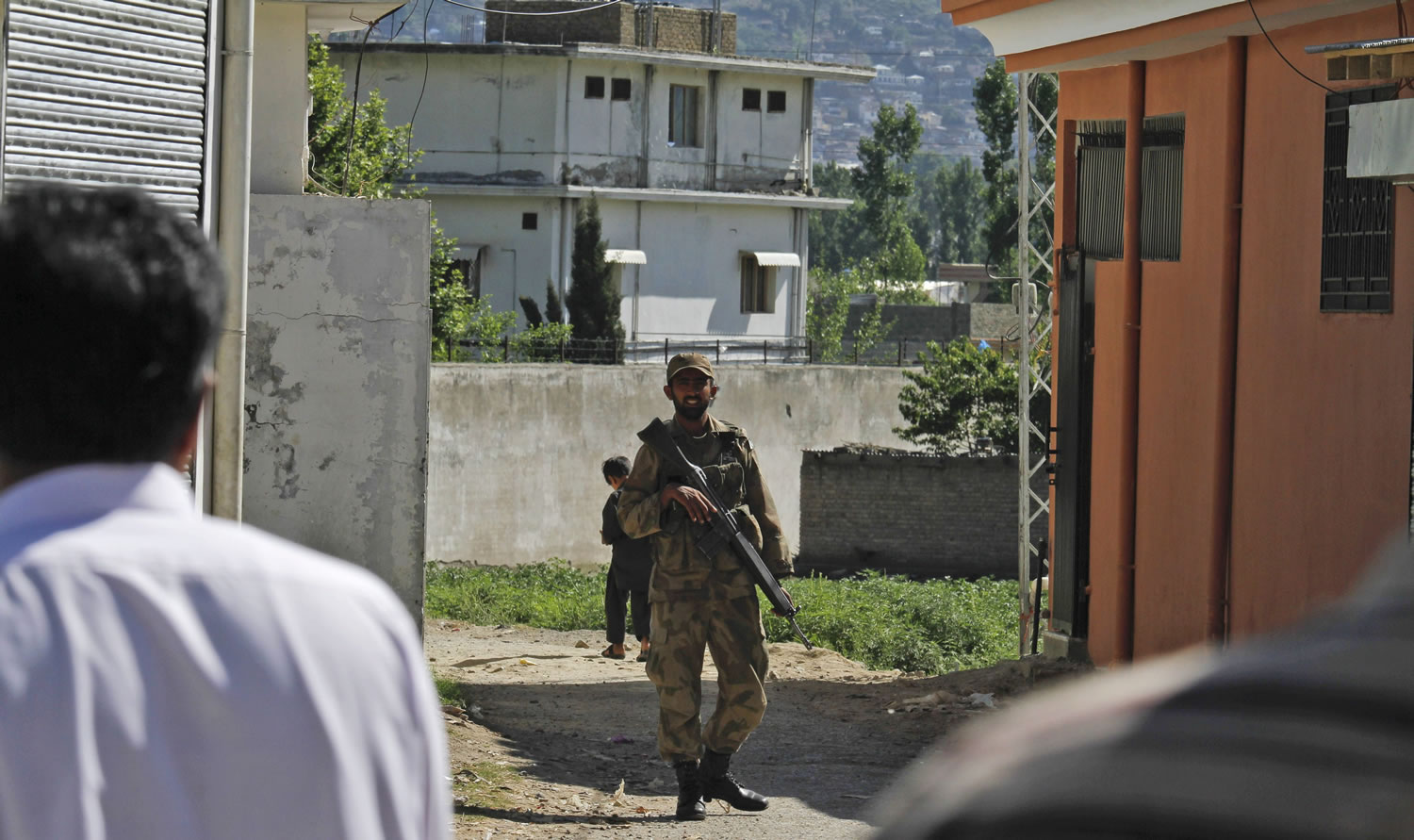 A Pakistan army soldier secures a street Sunday near the house in Abbottabad, Pakistan, where former al-Qaida leader Osama bin Laden was killed May 1.