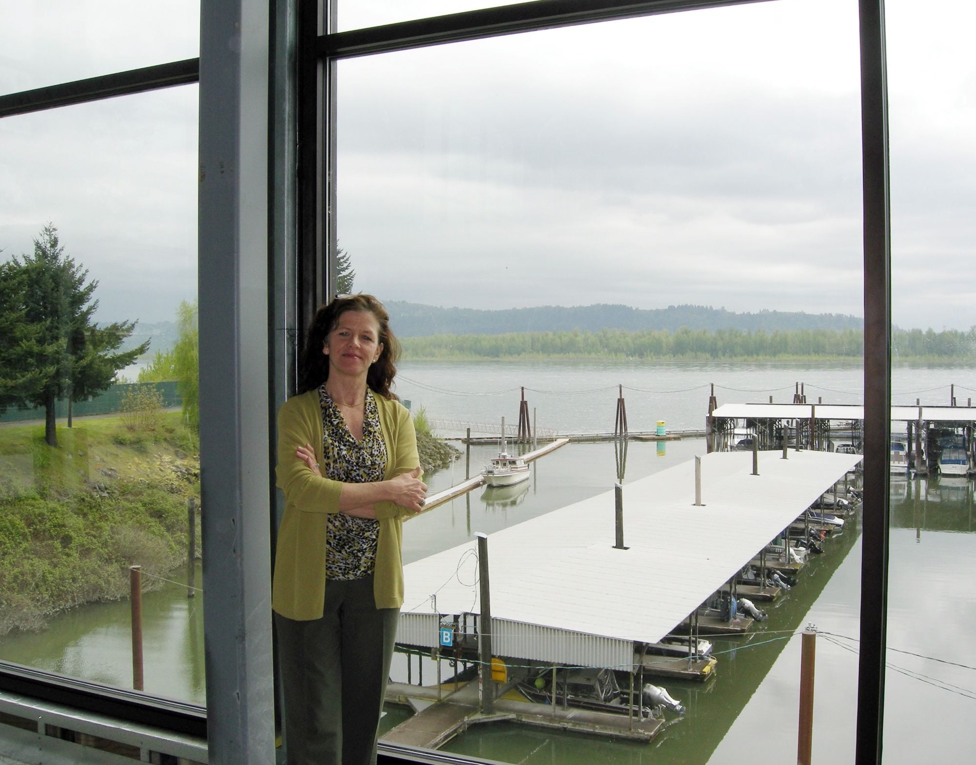 Kimberly Sherertz, widow of the late Vancouver businessman William Sherertz, stands beside the unfinished Columbia River-front restaurant that her husband had planned to open this summer as The Black Pearl, a replacement for the torn-down Parker House Restaurant overlooking the marina at the Port of Camas-Washougal.