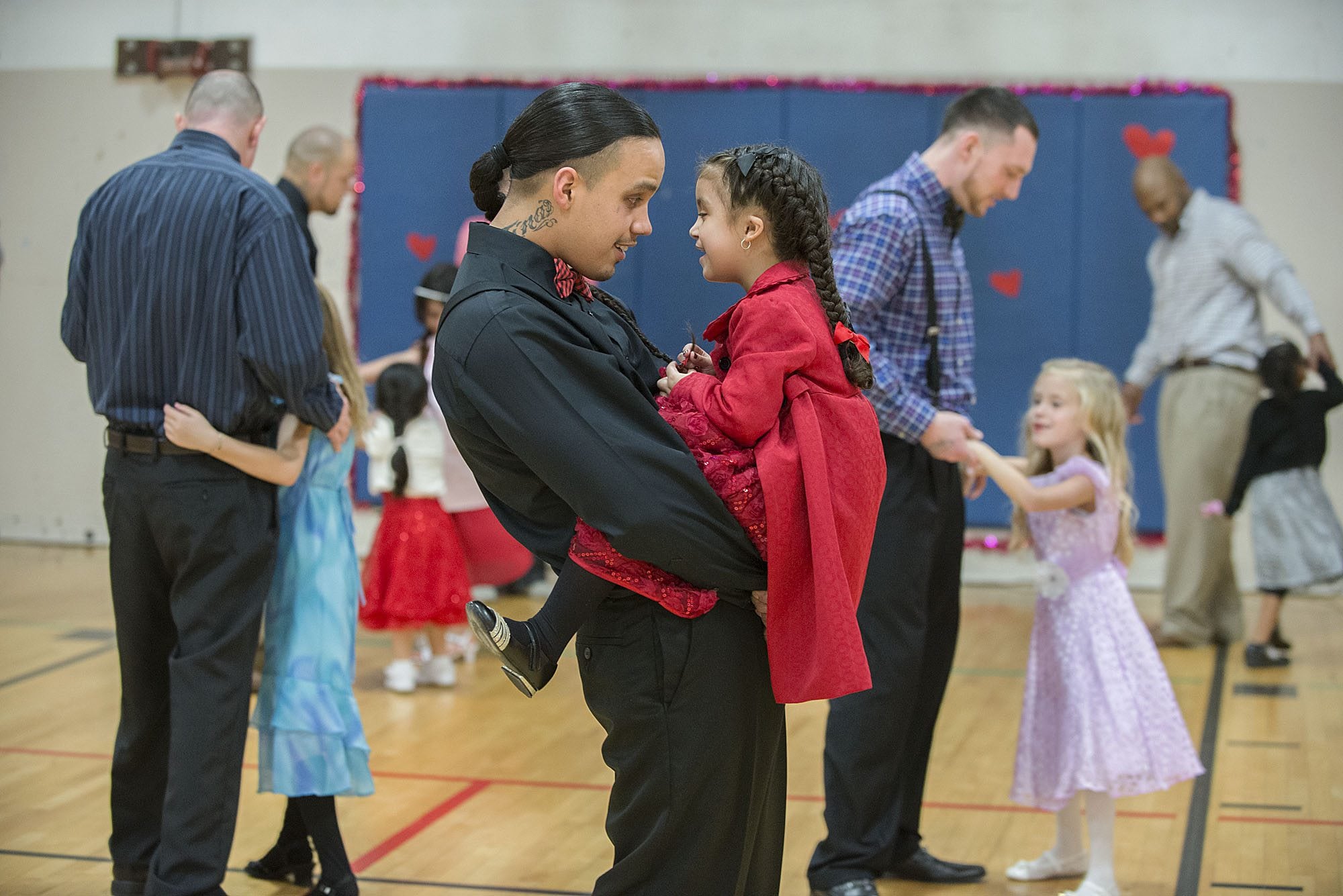 Kirk Hernandez, Jr., center, an inmate at Larch Corrections Center, takes a turn around the dance floor during a slow song with his daughter, Eternity, 5, on Saturday afternoon, Feb. 13, 2016 during the Larch Corrections Father Daughter Dance 2016.